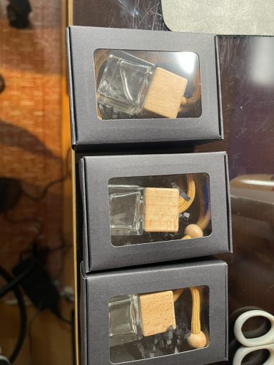three diffusers with wooden tops packed in three back boxes
