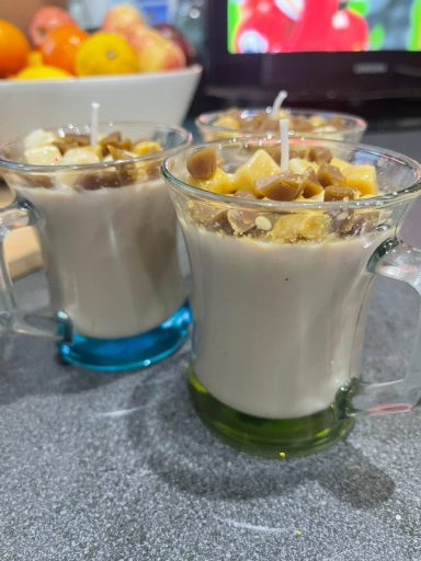 3 hot chocolate candles in drinking glasses with wax marshmallows
