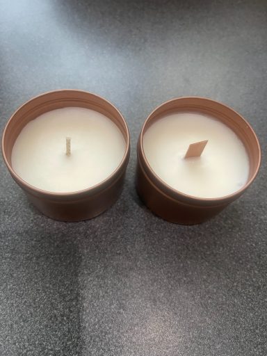 Close view of two candles setting with wood wicks
