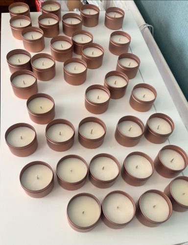collection of candles setting in gold tins
