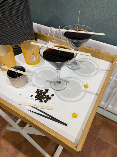 two candles in cocktails glasses setting