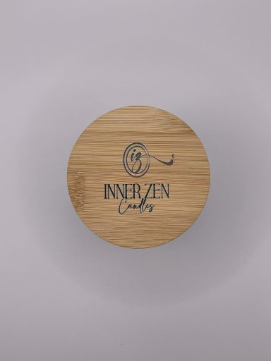 Circular wooden coaster with the engraved text "INNERZEN" and a stylised design.